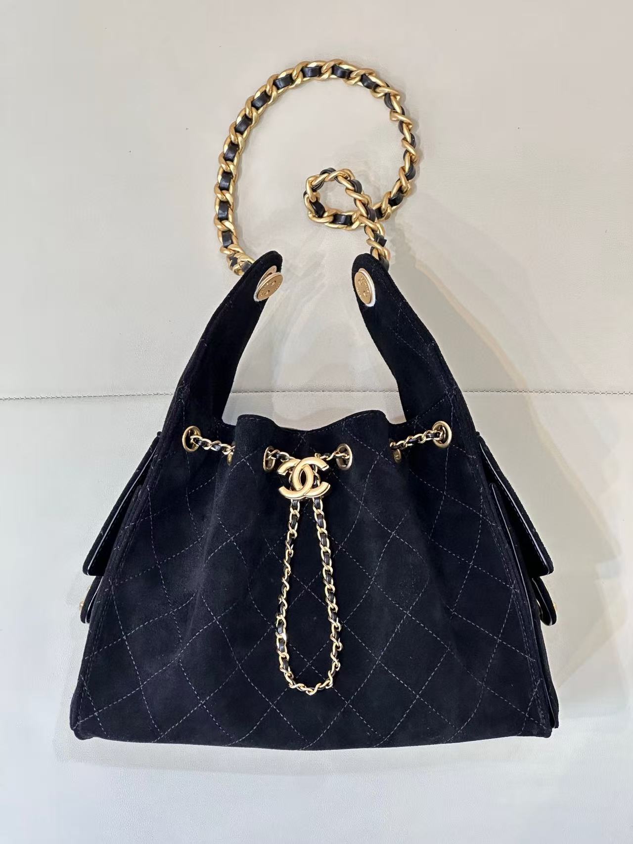 Chanel 25 Hobo Bag in black suede with gold-tone metal hardware