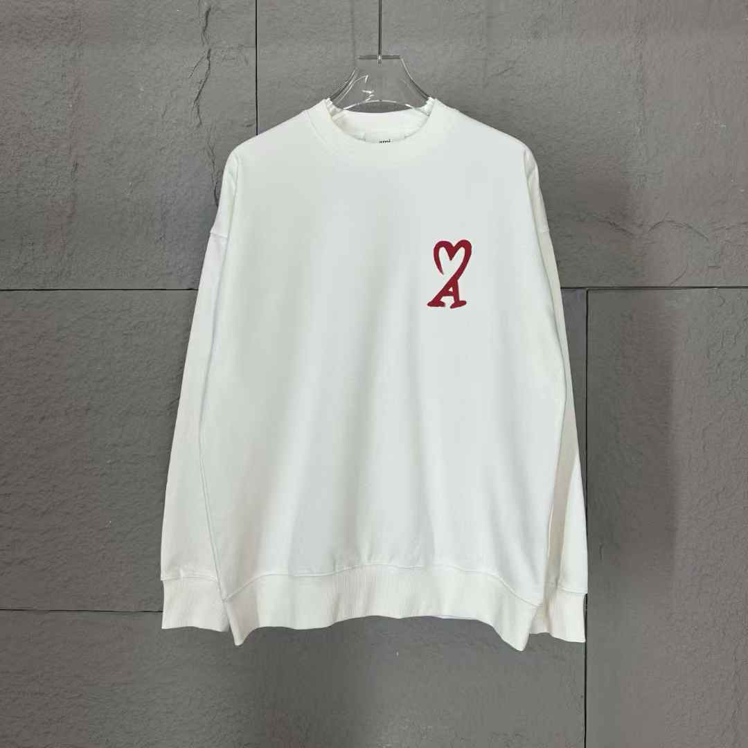 AMI Paris Ami de Coeur Sweatshirt in white with a red heart logo.