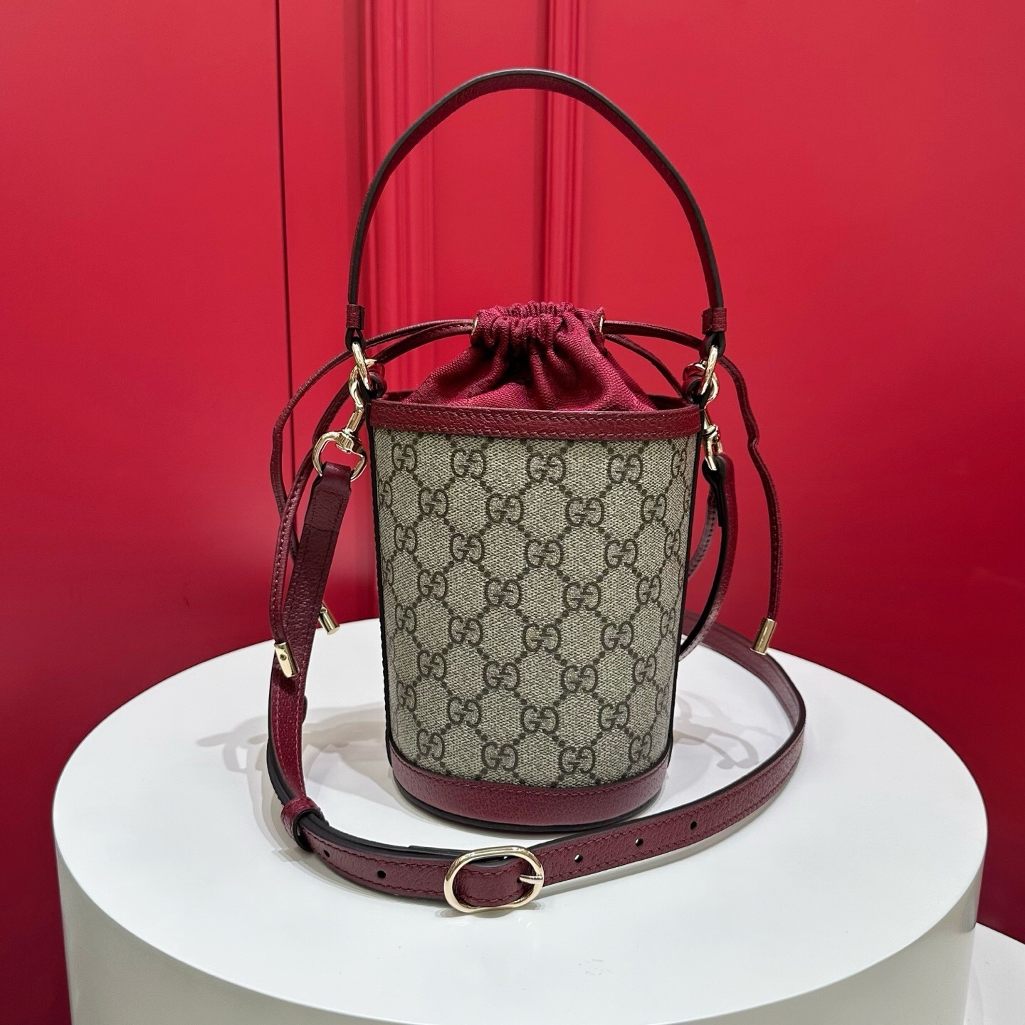 Gucci Ophidia Mini Bucket Bag in GG Supreme canvas with red leather trim