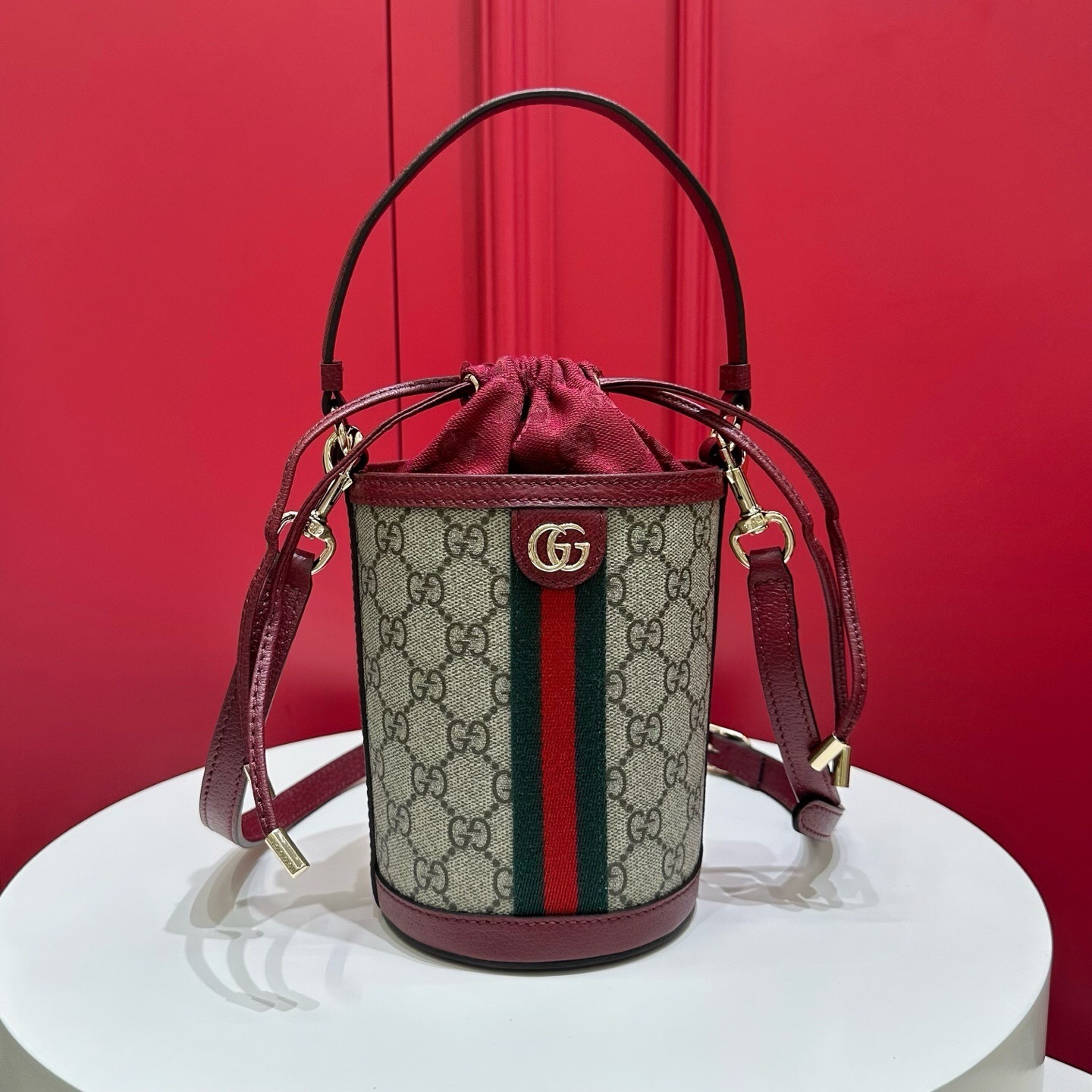 Gucci Ophidia Mini Bucket Bag in GG Supreme canvas with red leather trim