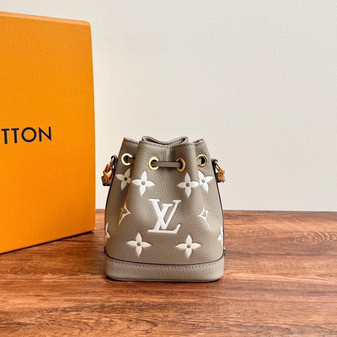 LV Nano Noe bag in bicolor Monogram Empreinte leather.