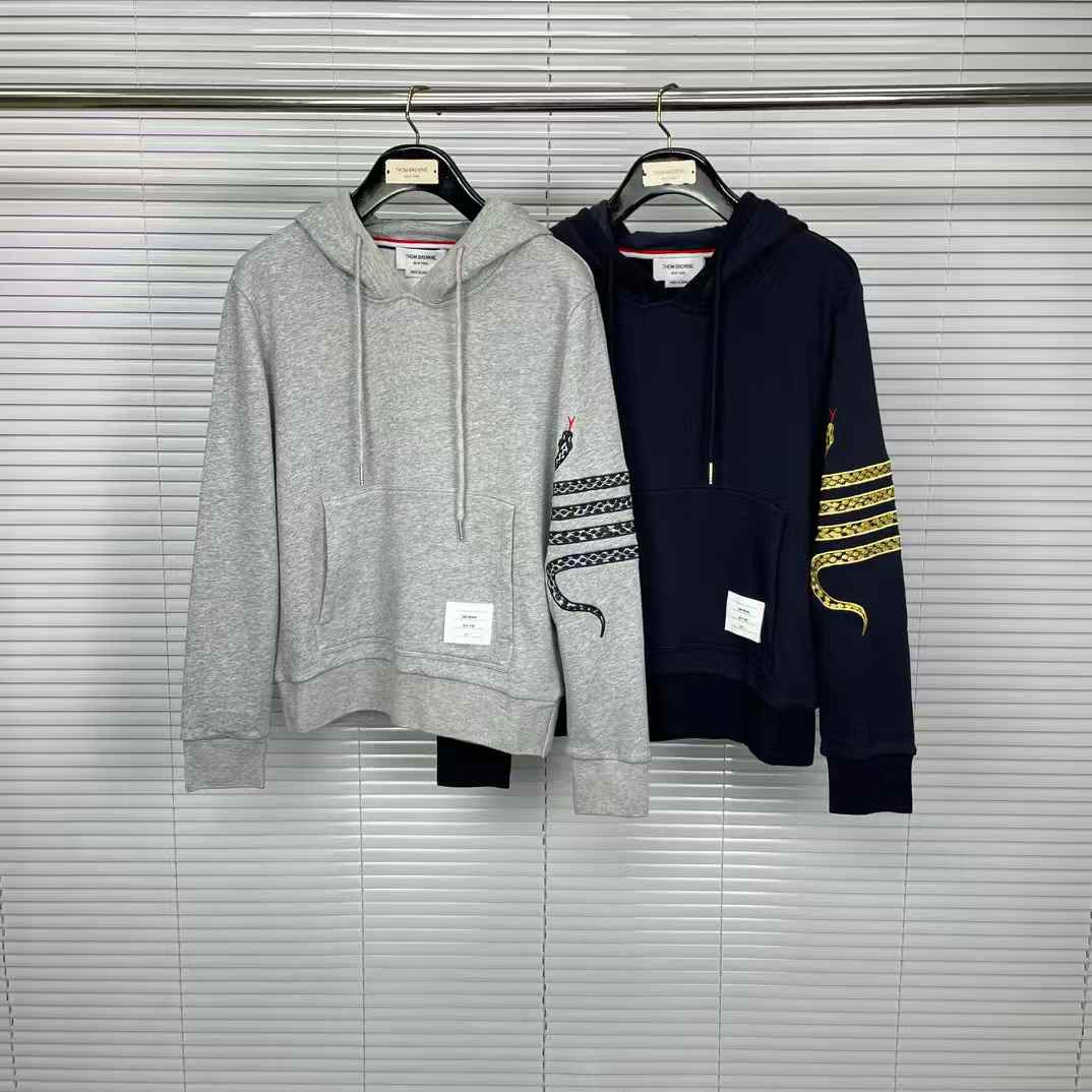 Thom Browne Lunar New Year hoodie with a gold 4-bar snake design