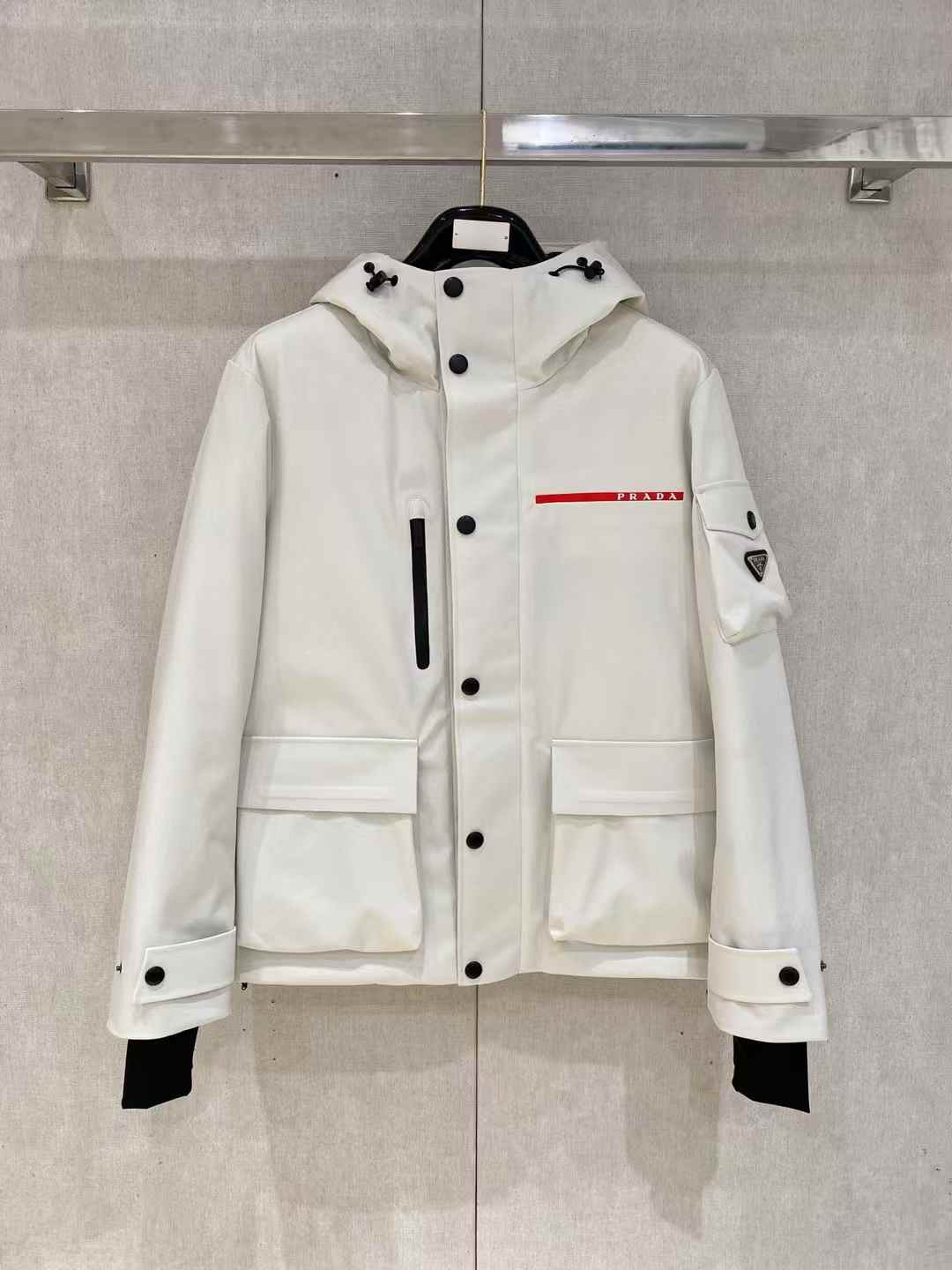 Prada Re-Nylon cropped convertible down jacket in white.