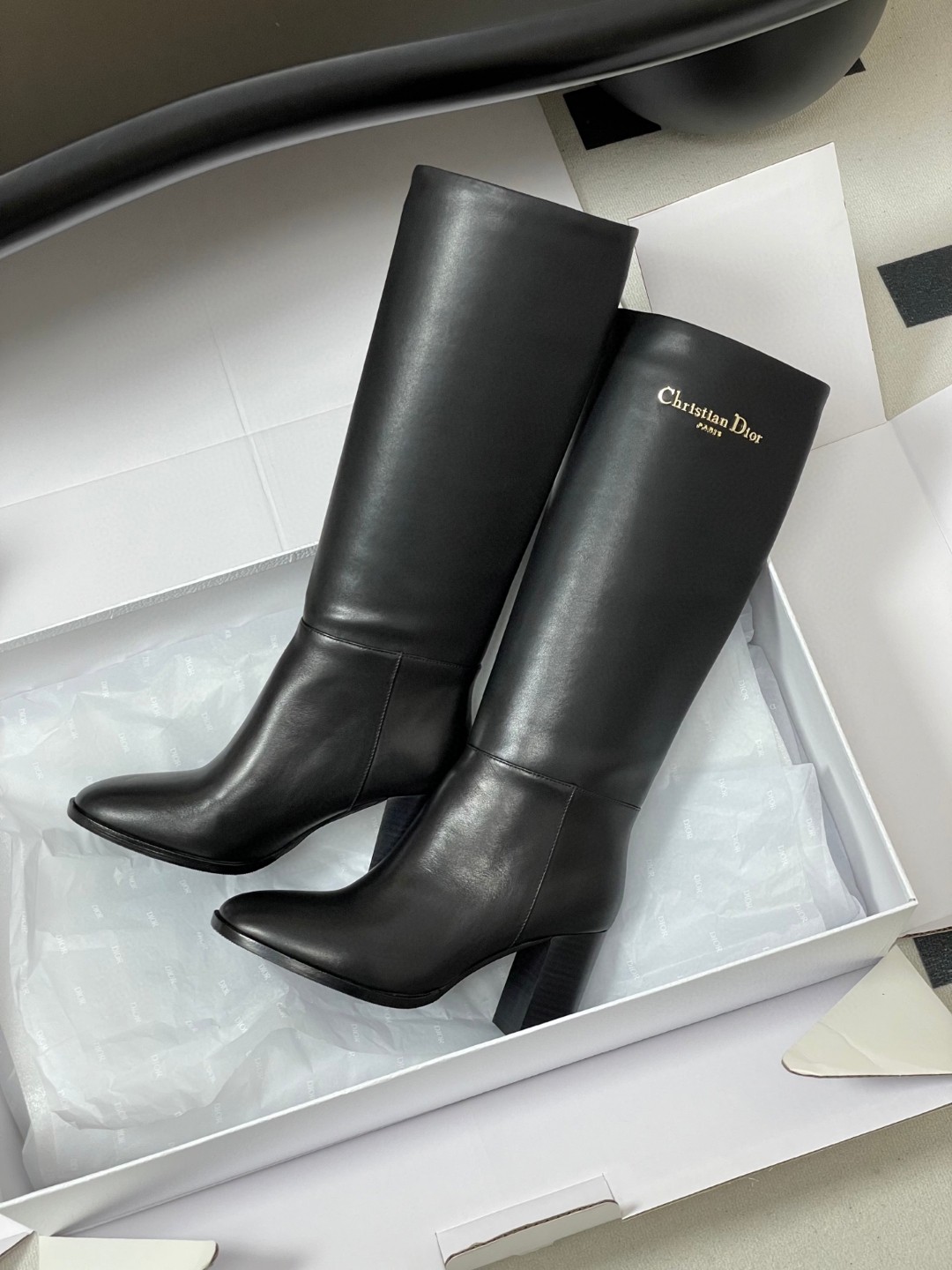 Dior D-Town Heeled Boot in black supple calfskin with a gold-finish metal Christian Dior Paris signature on the side.