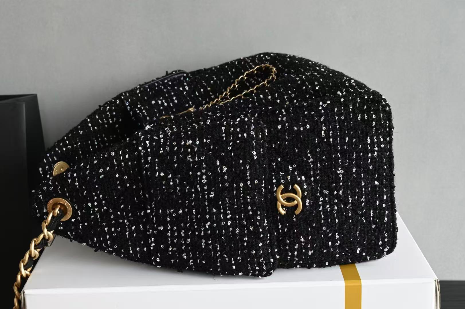 Chanel 25 small handbags black made of wool tweed with gold-tone metal hardware
