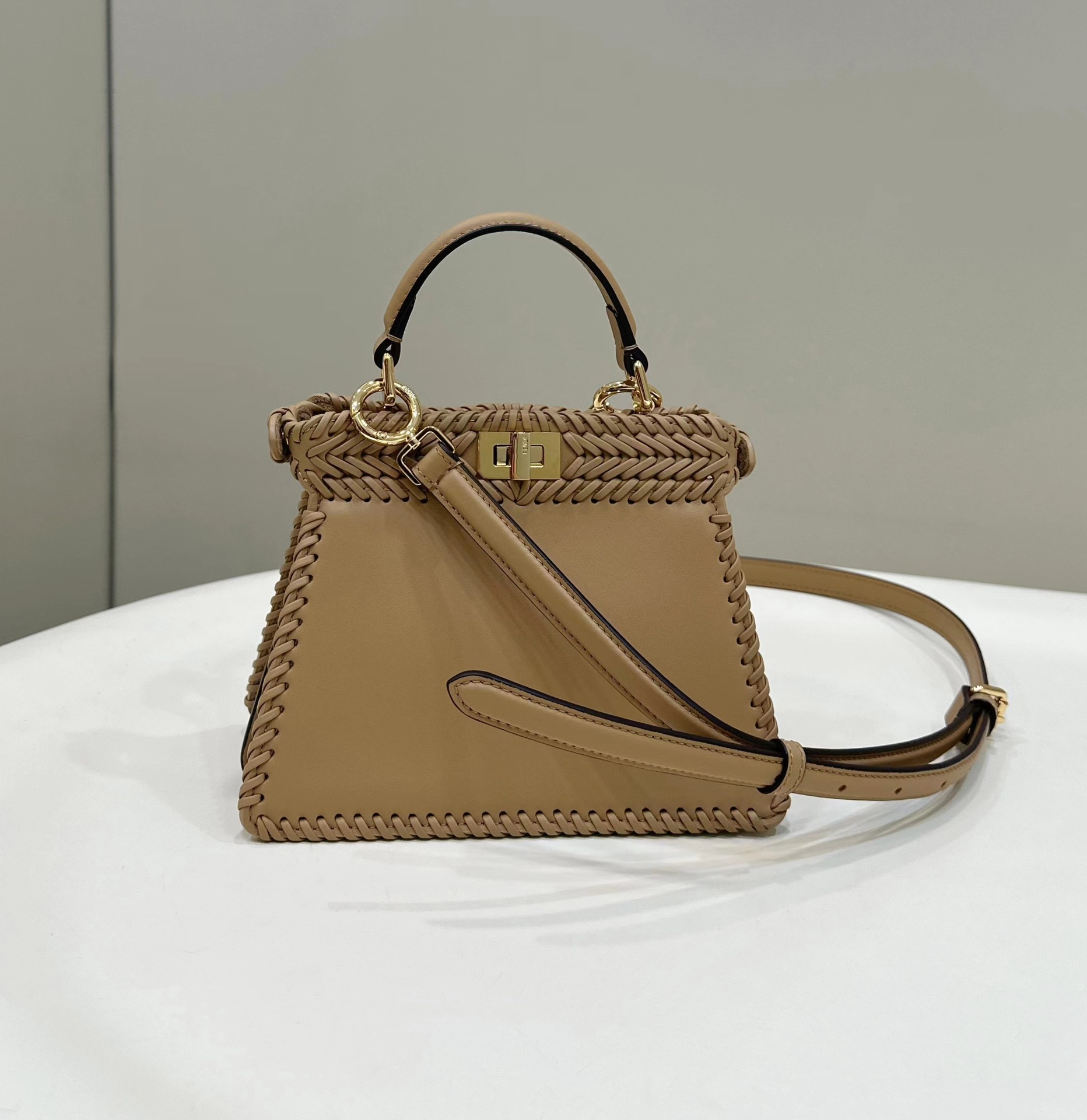 Fendi Peekaboo ISeeU small bag in champagne-colored interlaced leather.