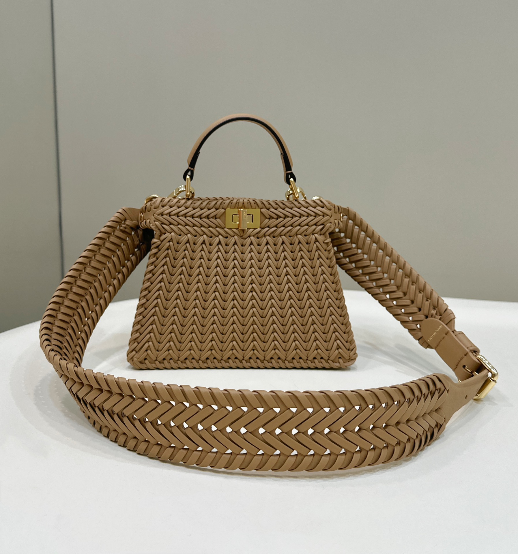 Fendi Peekaboo ISeeU small bag in champagne-colored interlaced leather.