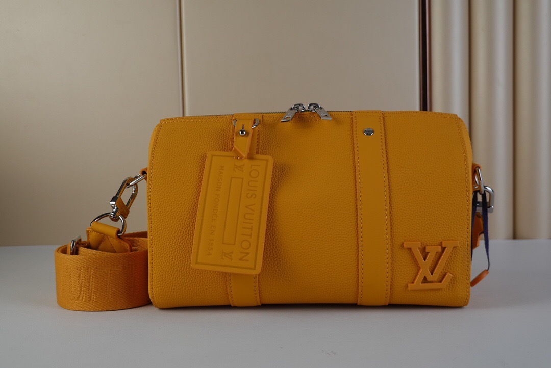 LV City Keepall bag in yellow Aerogram leather.
