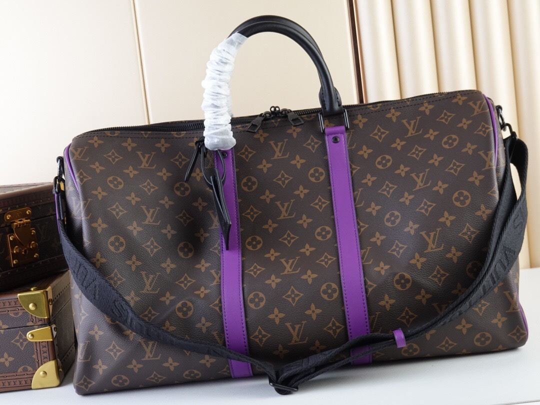 LV Keepall Bandoulière 50 travel bag with purple stripes.