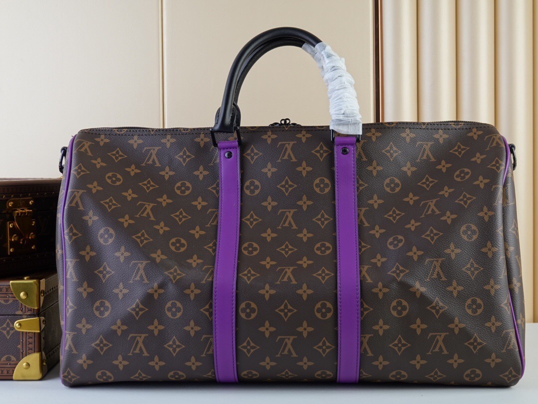LV Keepall Bandoulière 50 travel bag with purple stripes.