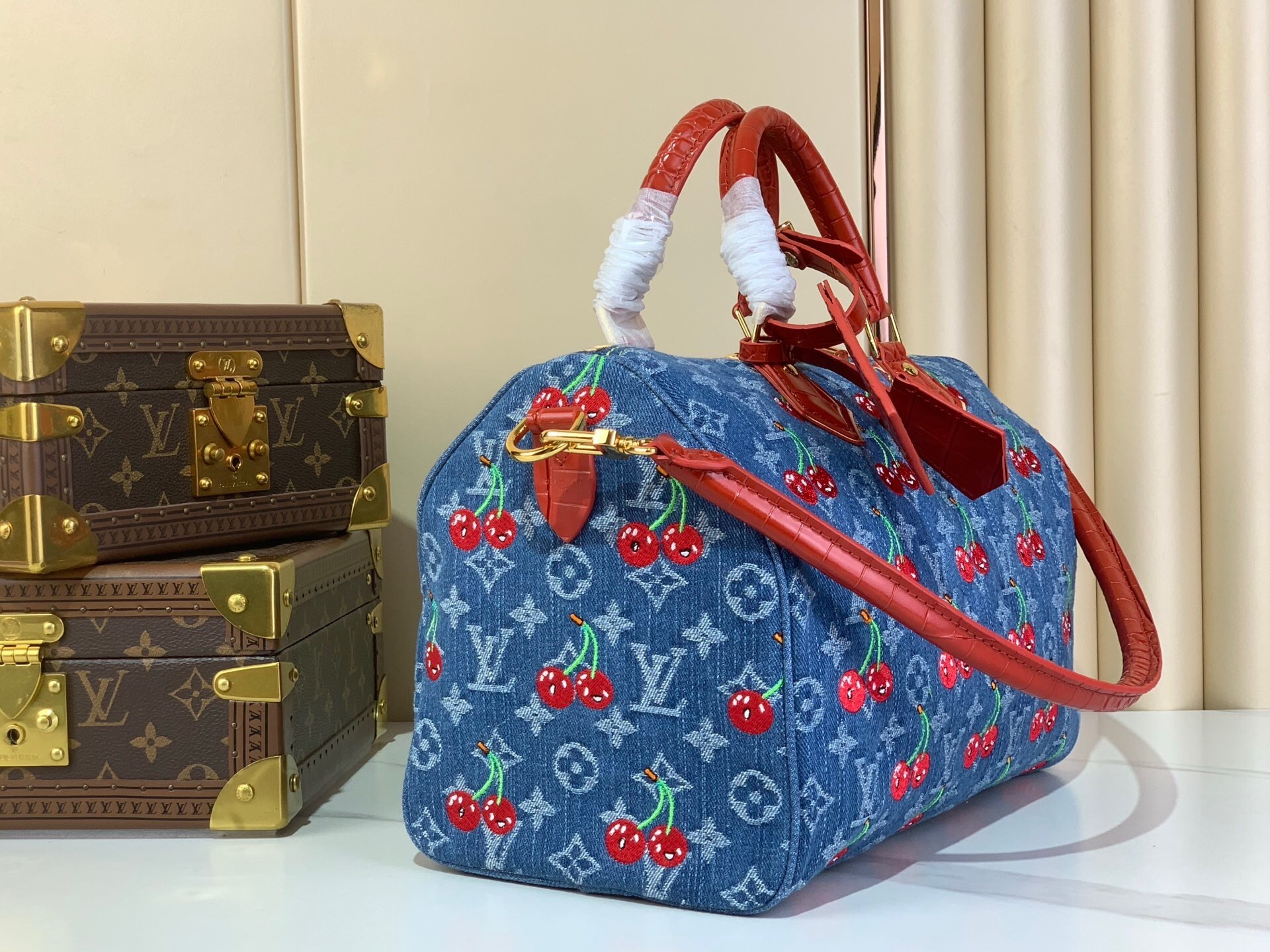 LV Speedy Soft 30 bag in Monogram Denim with a cherry motif from the Louis Vuitton x Murakami collection.
