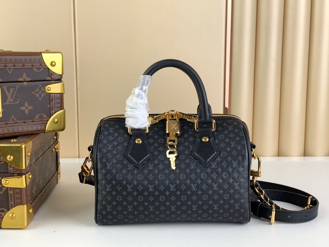 LV Speedy Bandoulière 20 bag in black Monogram Empreinte leather.