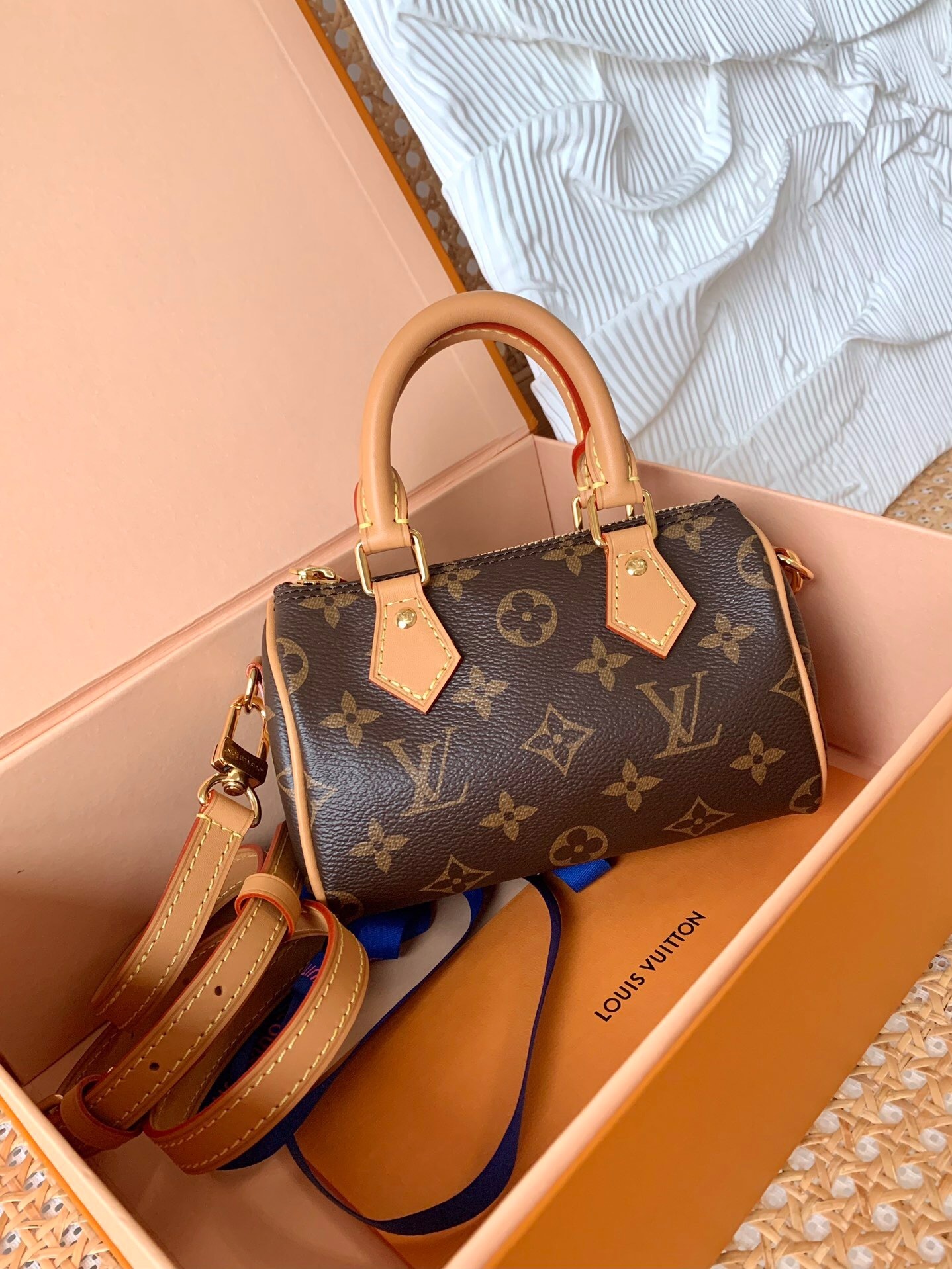 LV Nano Speedy bag in Monogram canvas cowhide-leather trim and gold-color hardware.