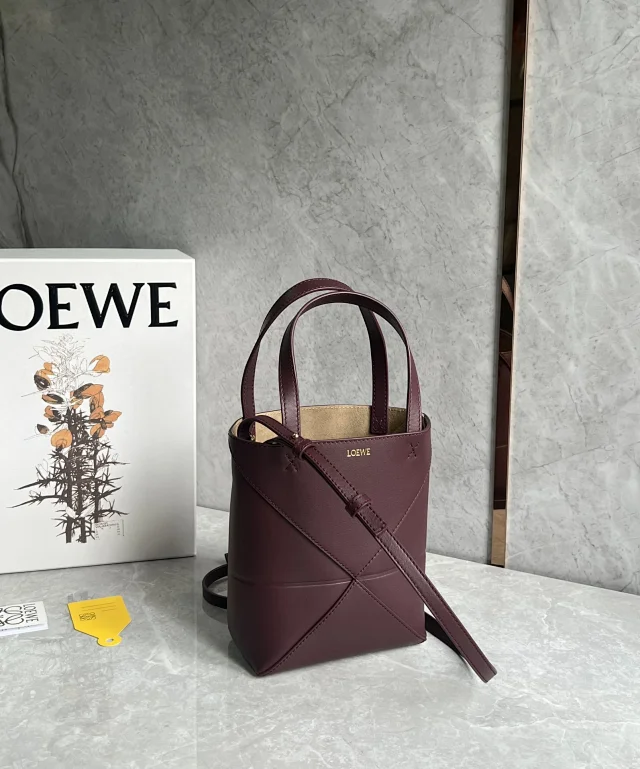 Loewe Mini Puzzle Fold Tote in shiny calfskin in a dark burgundy or maroon color