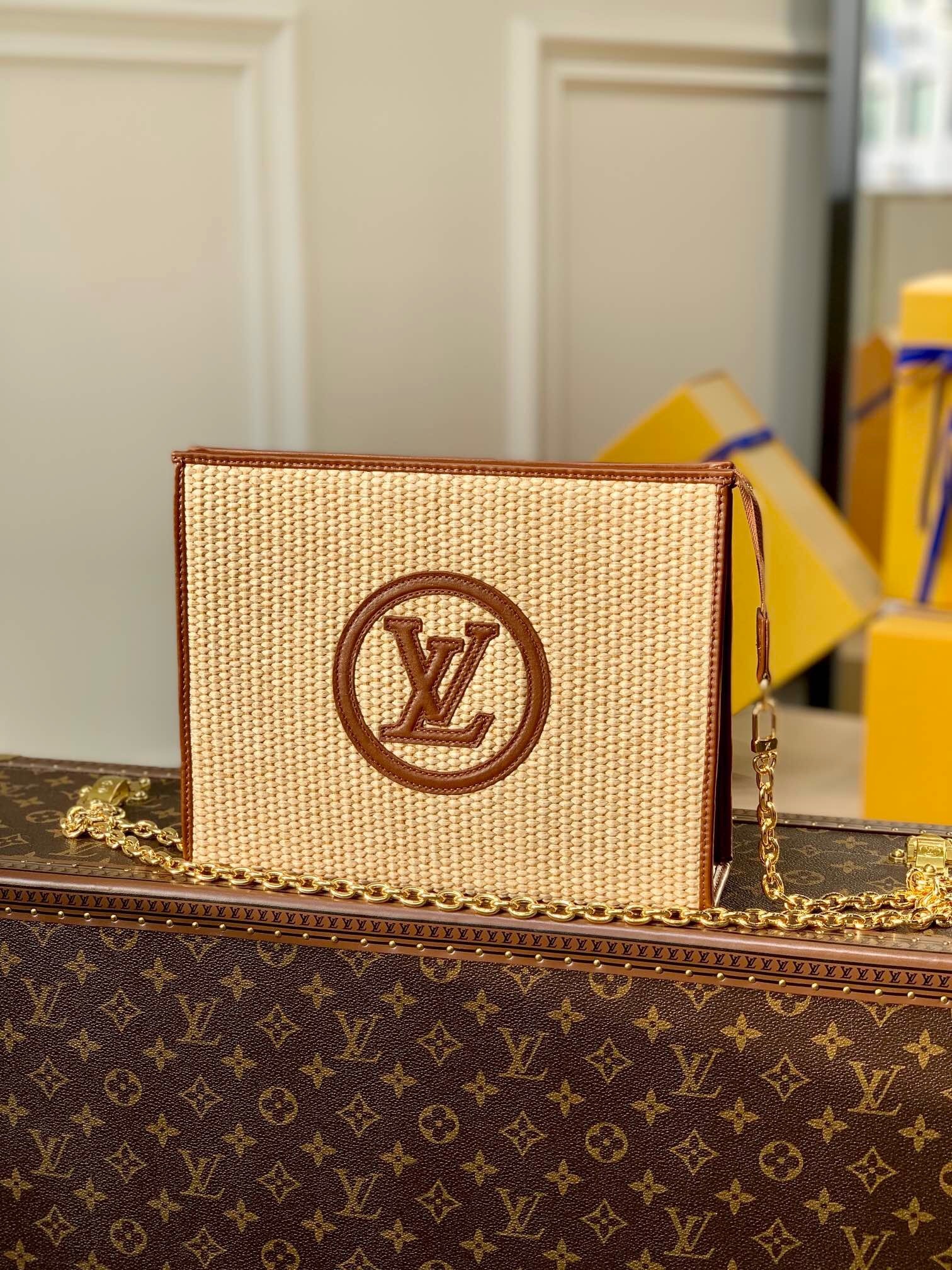 LV Raffia Poche Toilette 26 cosmetic pouch on a chain.