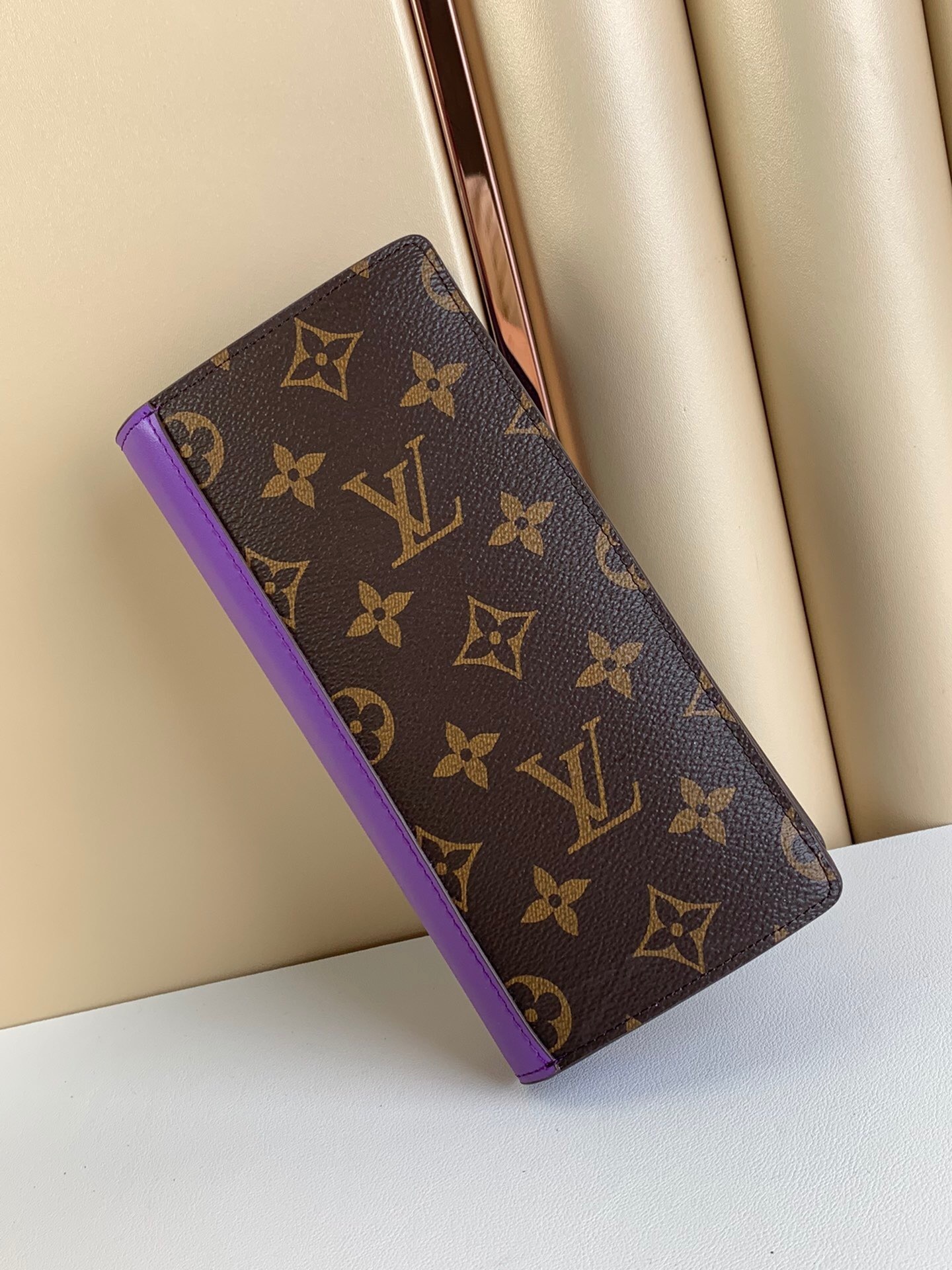 LV Brazza wallet in Monogram canvas with a purple leather trim.