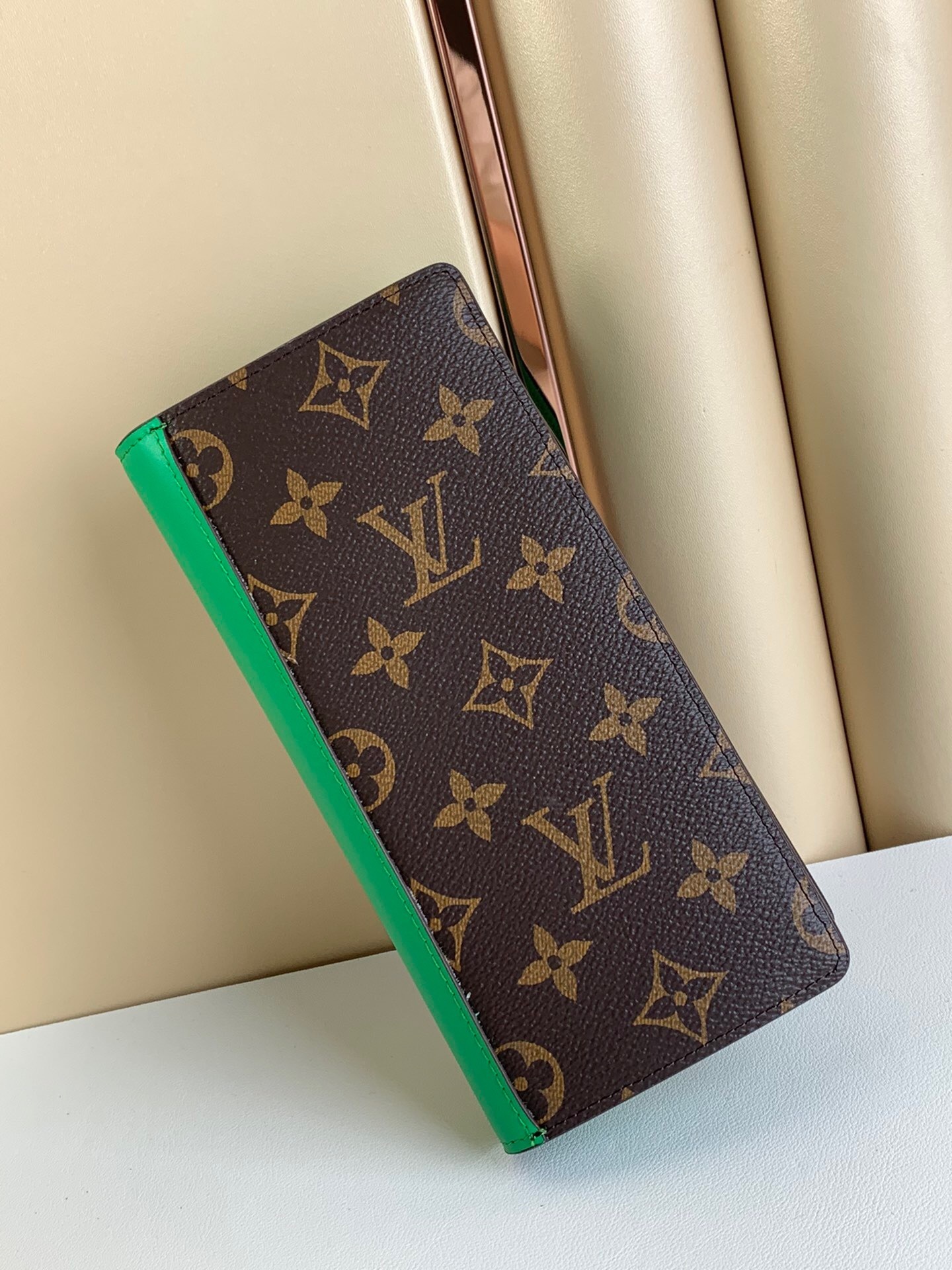 LV Brazza wallet in Monogram canvas with a green leather trim.