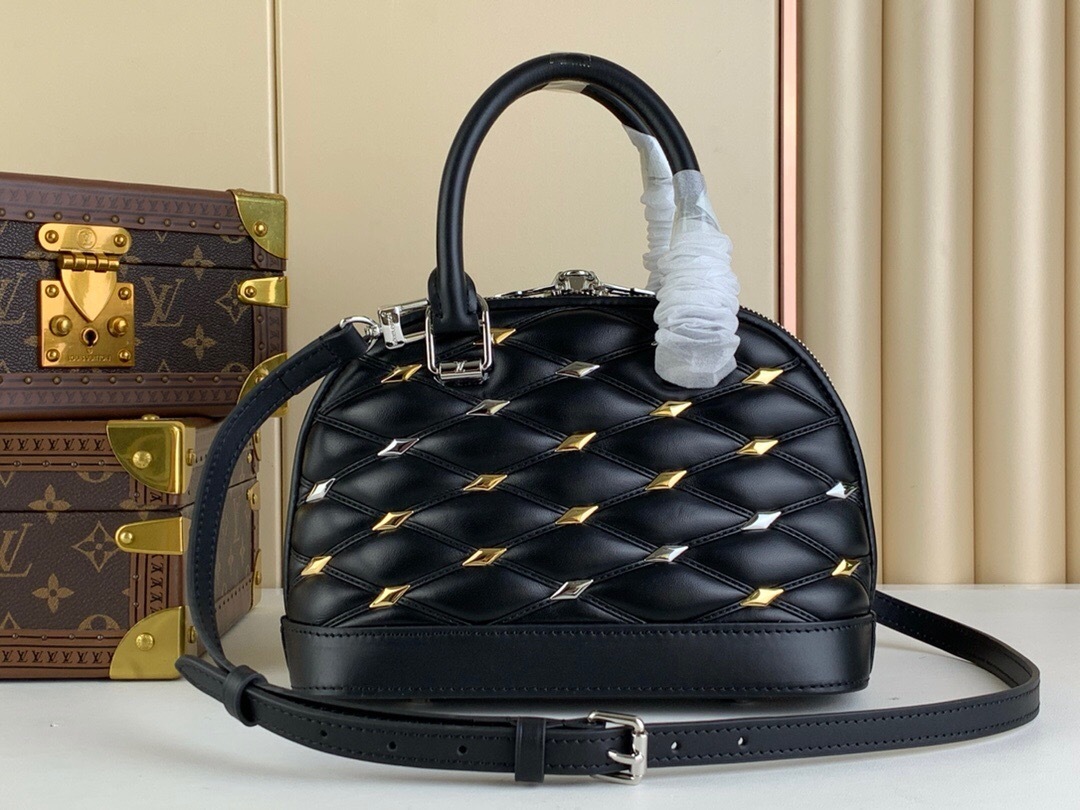 LV Alma bag in black leather with a quilted Malletage pattern and silver and gold studs