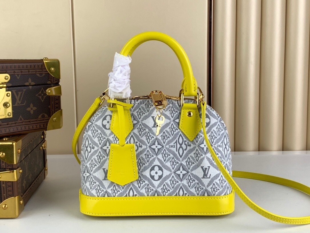 LV Alma BB handbag in a light greige and yellow color