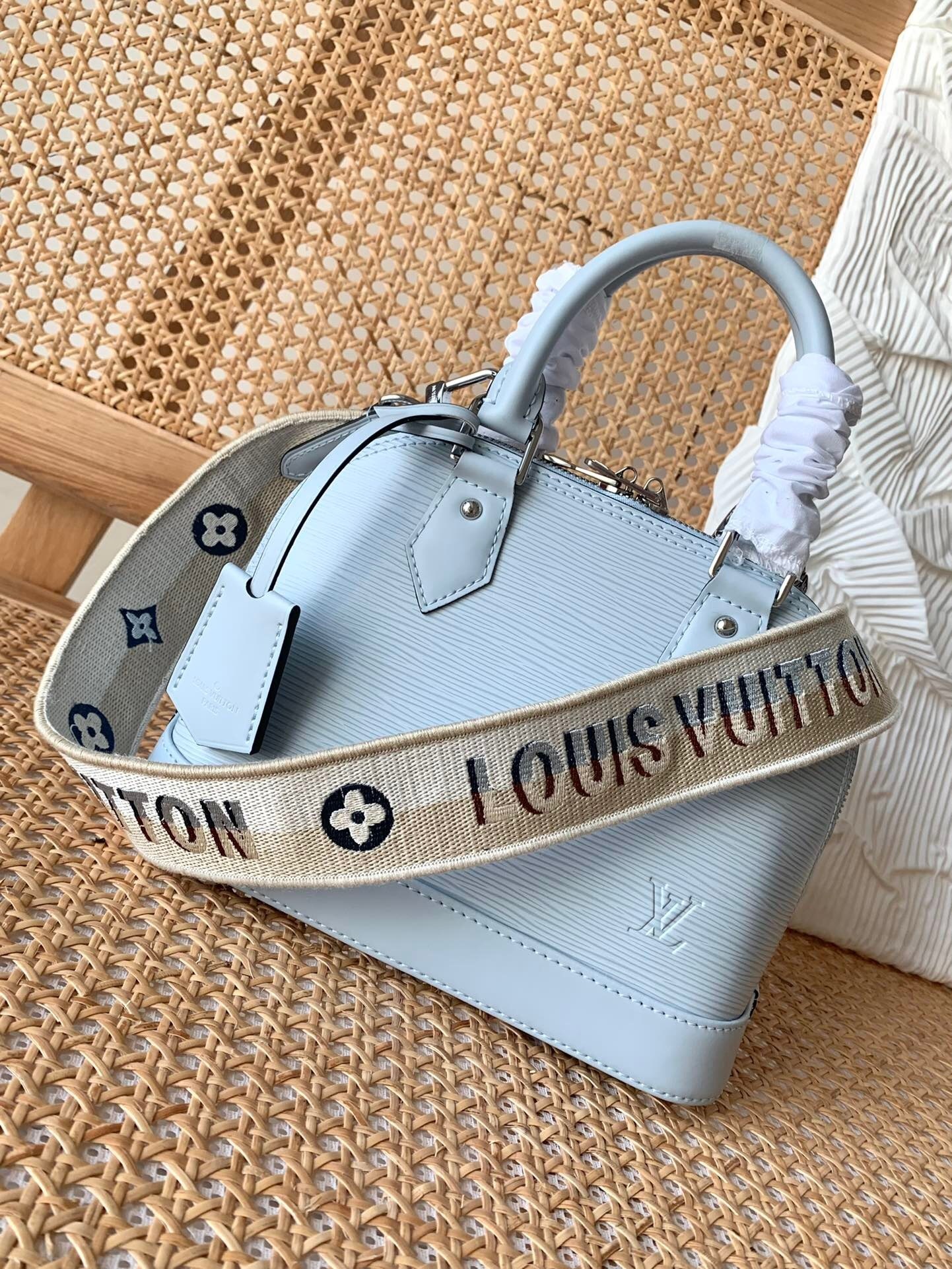 LV Alma BB bag with a wide detachable strap.