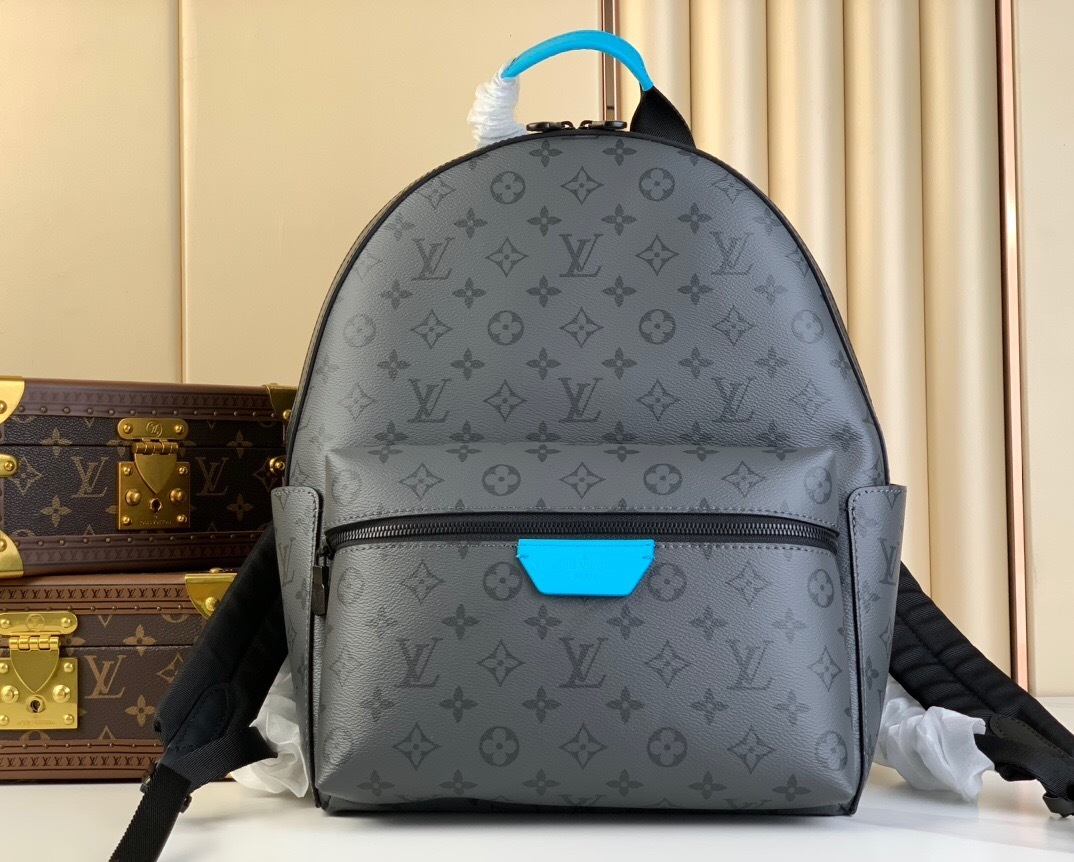 LV Discovery Backpack in Monogram Eclipse canvas with a front zipped pocket and side pockets