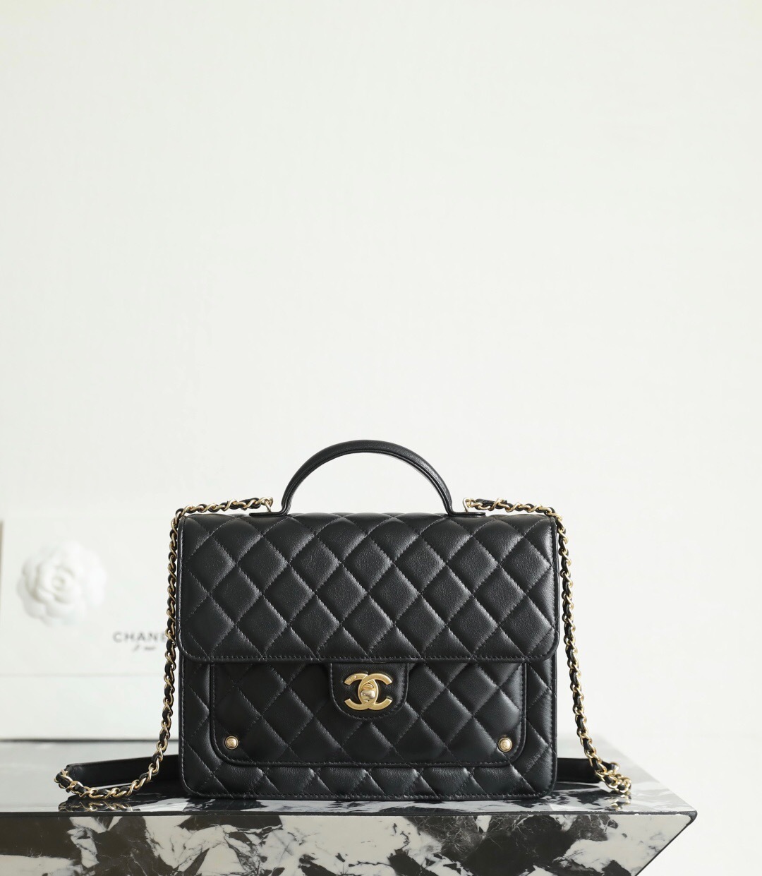 Chanel 25 medium handbag in black grained calfskin with gold-tone metal hardware
