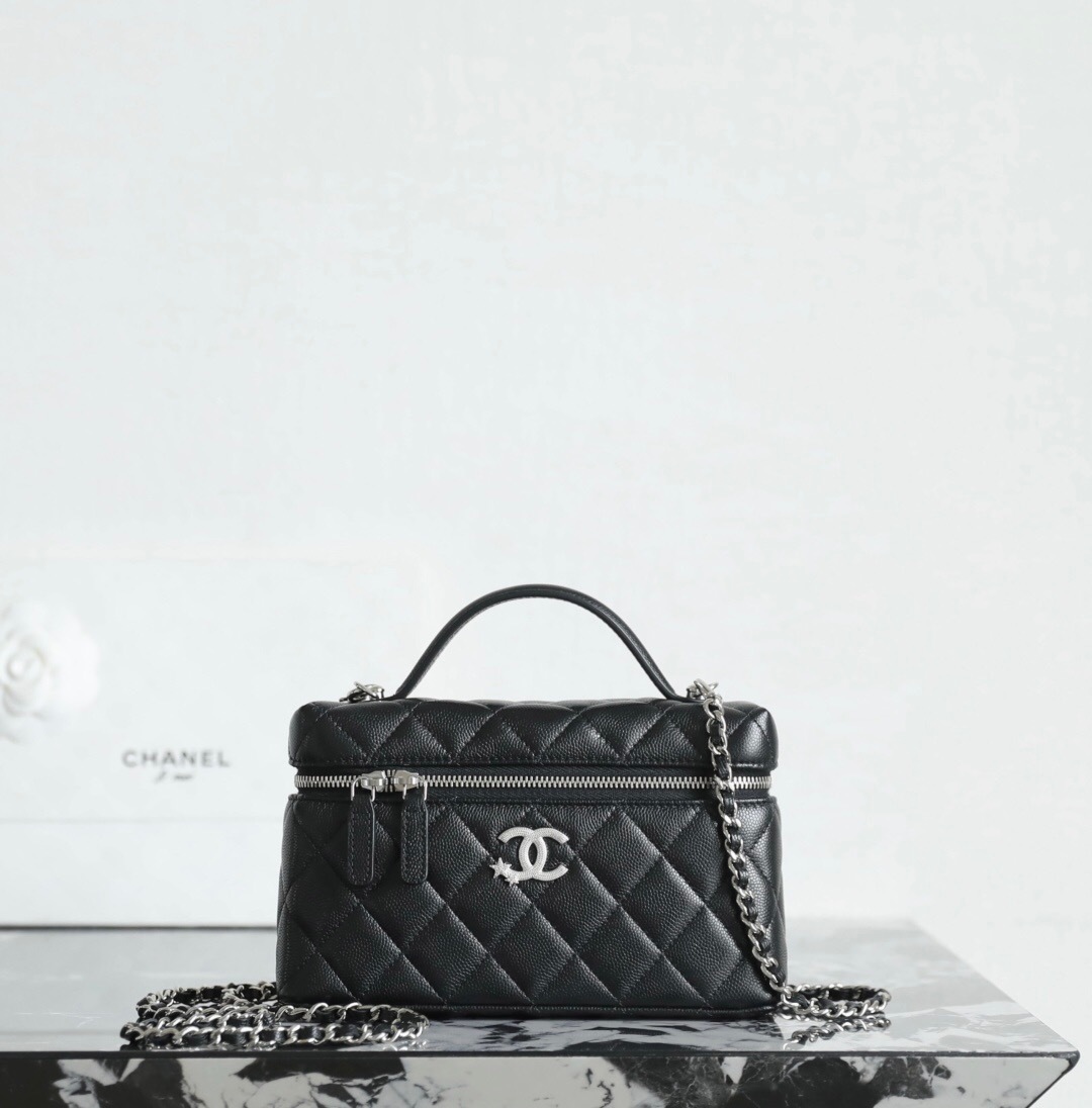 Chanel Chanel Vanity Case bag in black caviar leather with a top handle and chain strap.