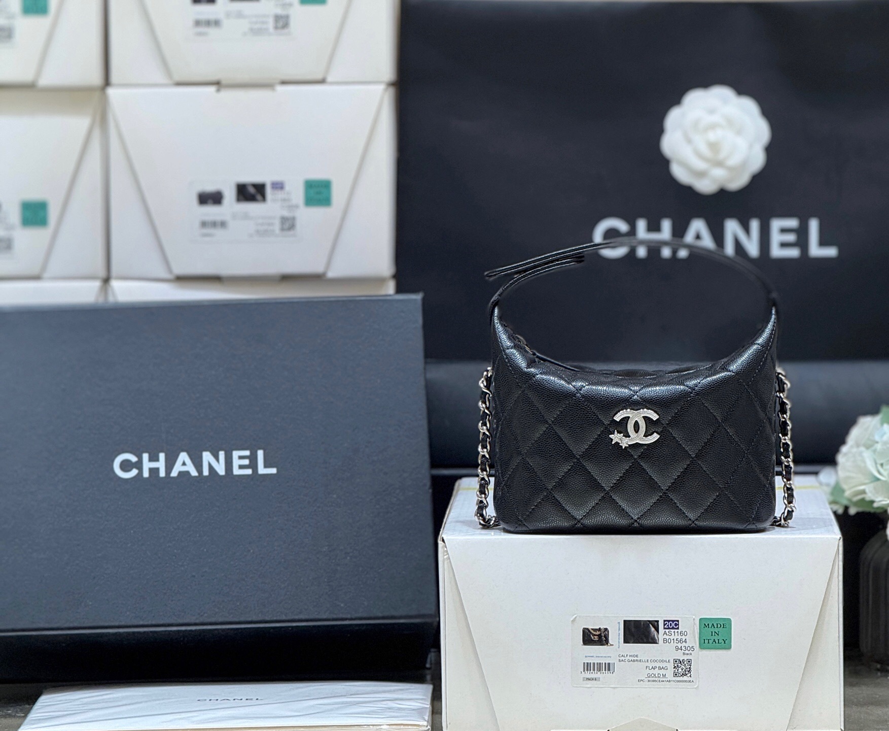 Chanel quilted black leather bag with a silver-tone chain strap and a CC logo on the front.