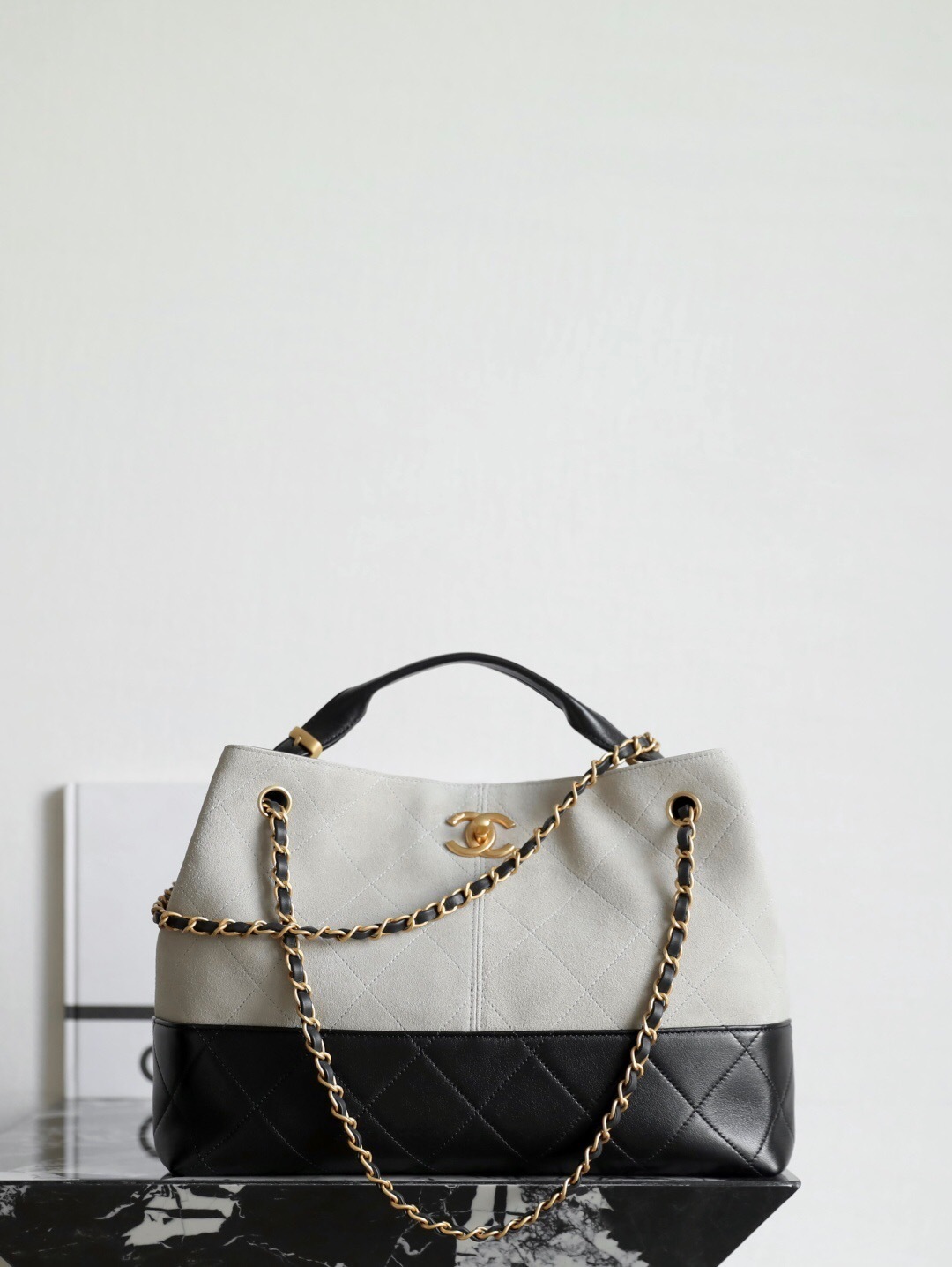Chanel two-tone handbag with a gold-tone chain strap CC logo