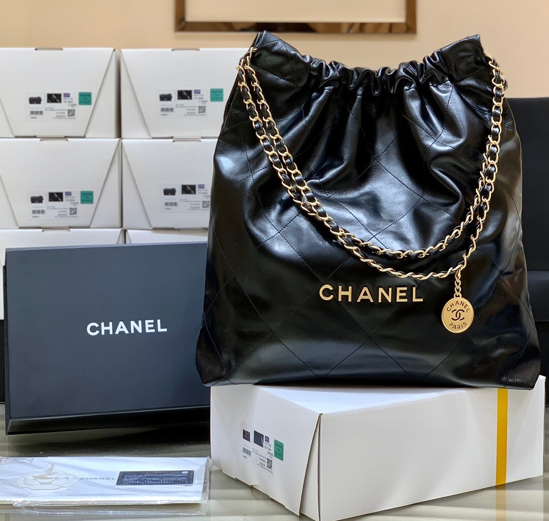 Chanel 22 handbag black shiny calfskin with gold-tone metal hardware.