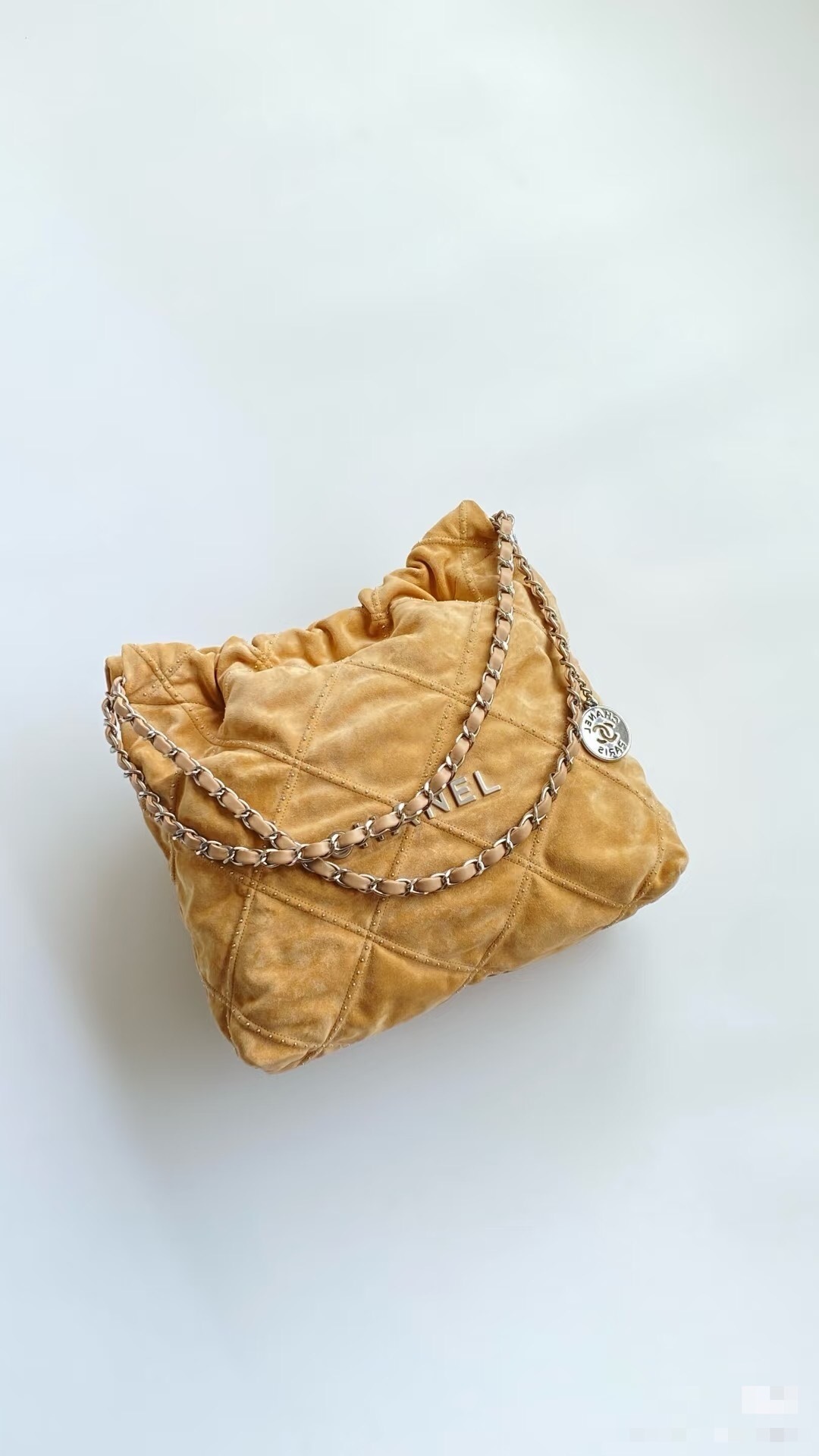 Chanel 22 bag in apricot-colored Bonaudo suede calfskin with an antique silver buckle