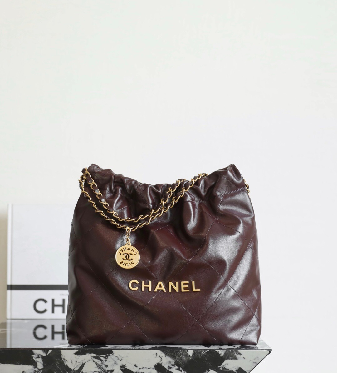 Chanel 22 handbag in dark brown shiny calfskin with gold-tone metal hardware