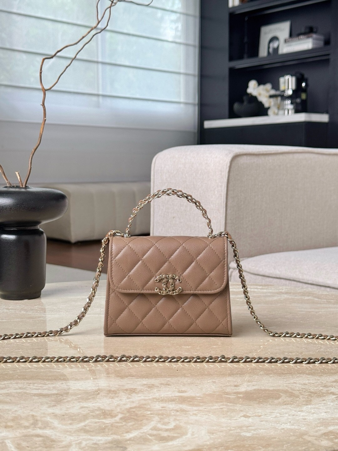 Chanel 23P Top Handle Kelly Clutch with Chain in caramel caviar leather.