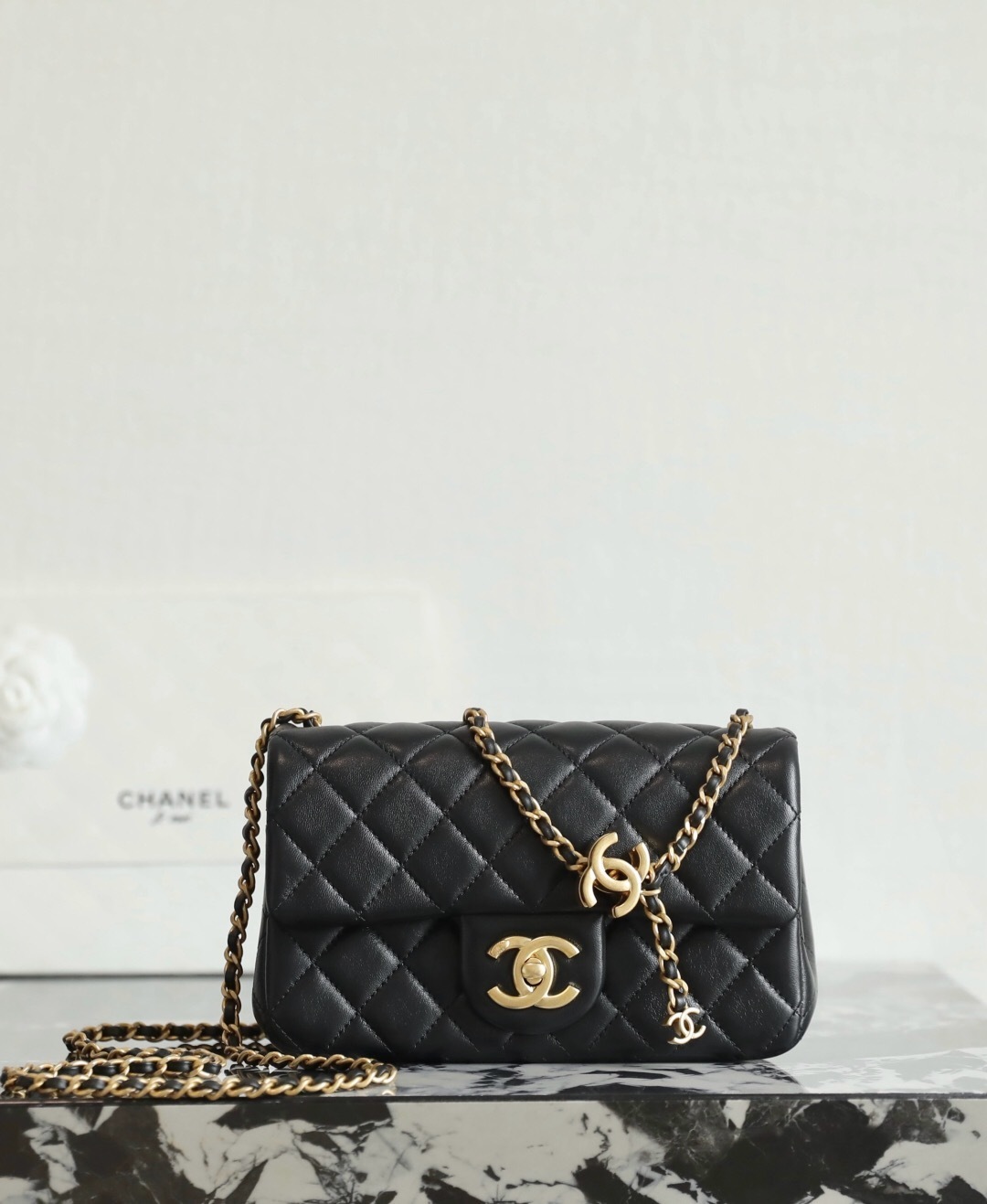 Chanel Classic Flap bag quilted leather with a gold-tone chain strap shoulder bag and the signature interlocking CC logo on the front.