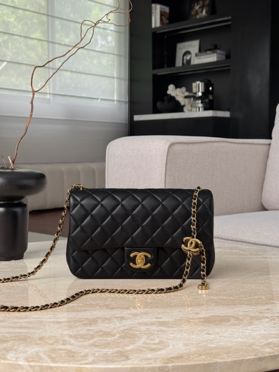 Chanel Classic Flap handbag in black quilted leather with a gold-tone chain strap shoulder bag