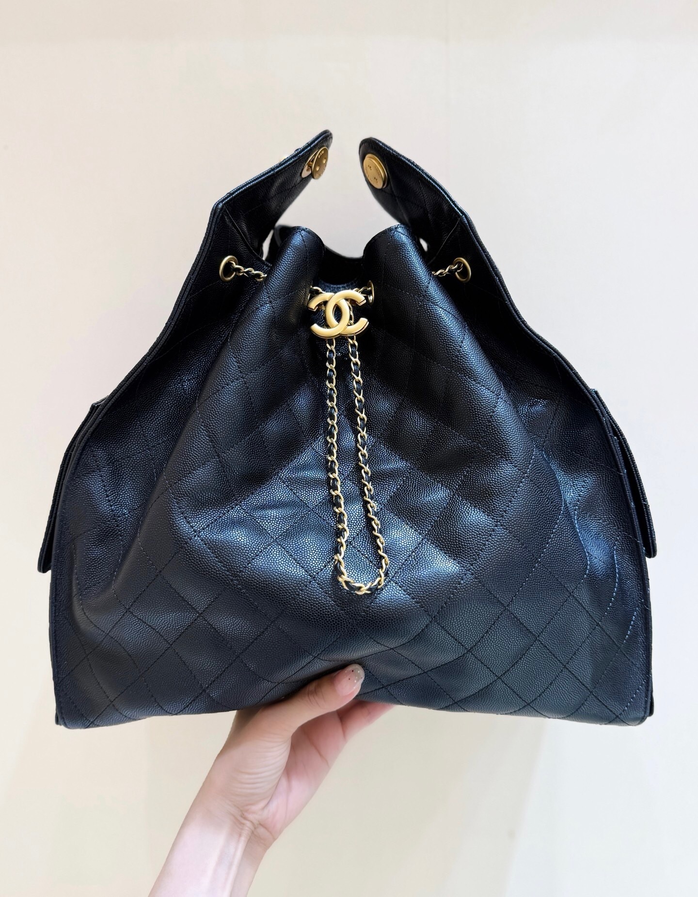 Chanel 25 handbag in black grained calfskin with gold-tone metal hardware bucket bag