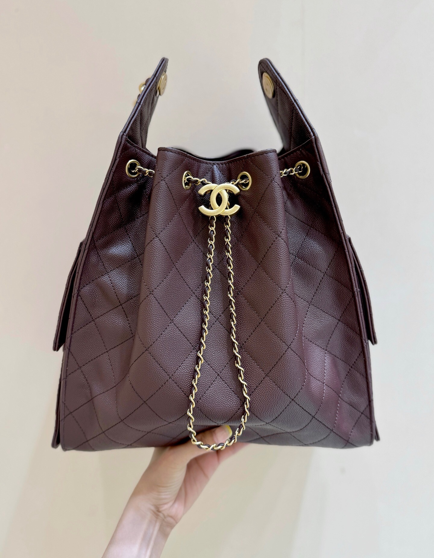 Chanel 25 hobo bag in dark brown quilted caviar leather with antique gold hardware