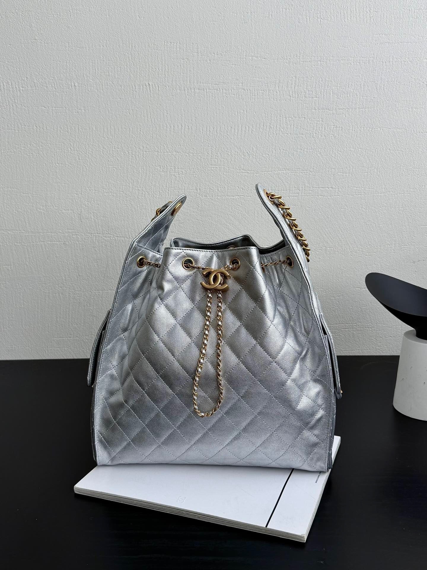 Chanel 25 handbag Maxi Hobo Bag, in a light-colored, quilted leather.