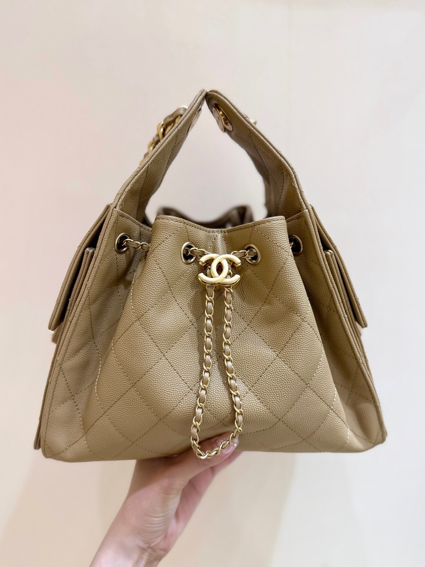 Chanel 25 handbag Maxi Hobo Bag, in a light-colored, quilted leather.