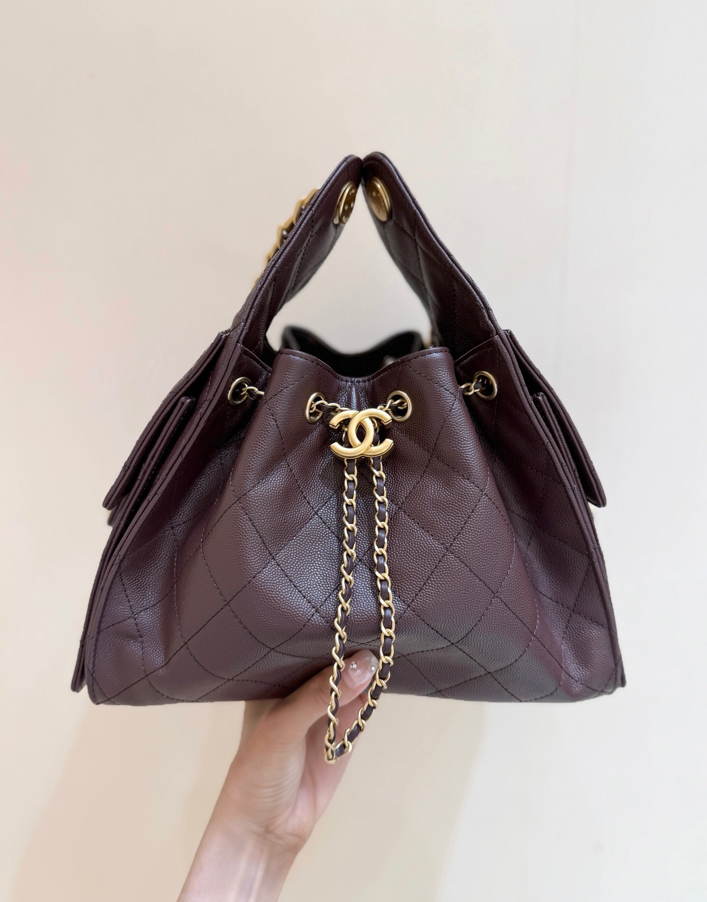 Chanel 25 handbag Maxi Hobo Bag, in a light-colored, quilted leather.