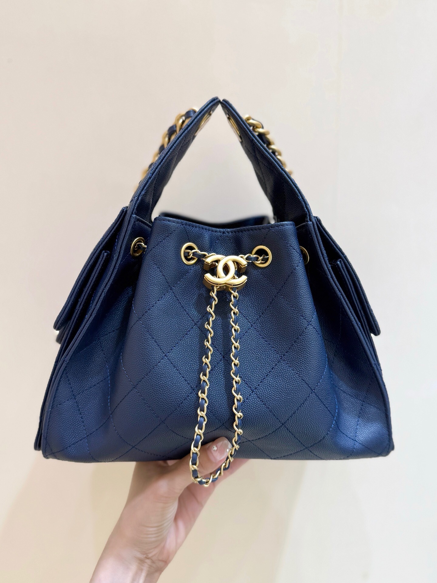 Chanel 25 handbag Maxi Hobo Bag, in a light-colored, quilted leather.