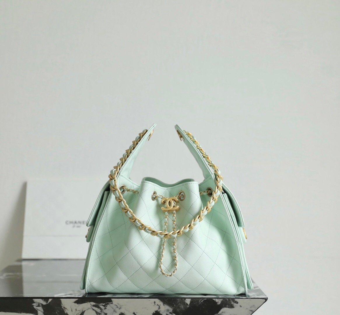 Chanel 25 handbag Maxi Hobo Bag, in a light-colored, quilted leather.