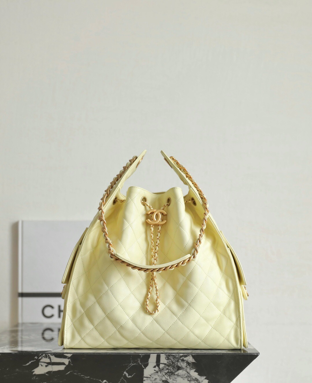 Chanel 25 handbag Maxi Hobo Bag, in a light-colored, quilted leather.