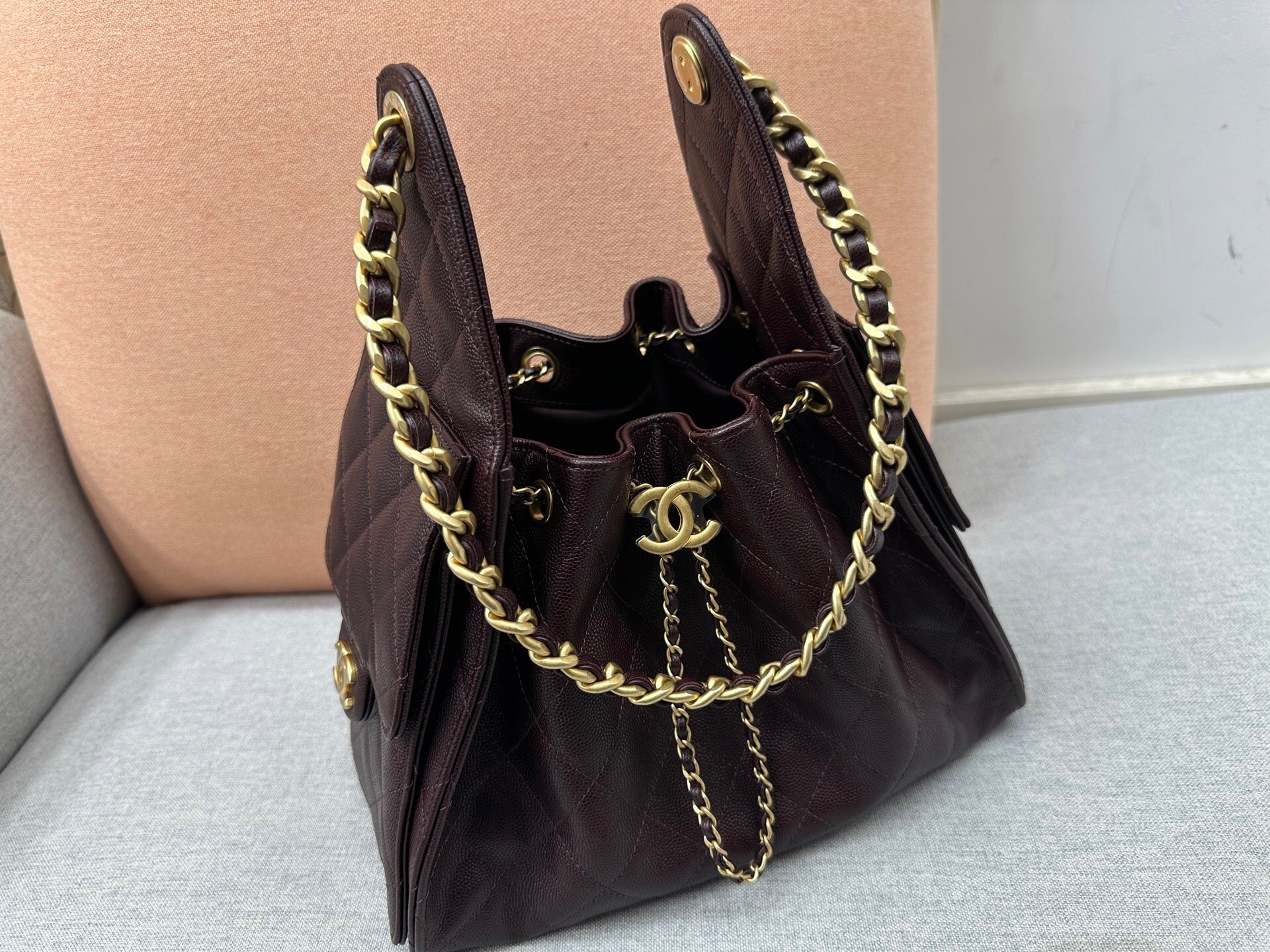 Chanel 25 handbag in dark brown caviar leather with antique gold hardware bucket bag