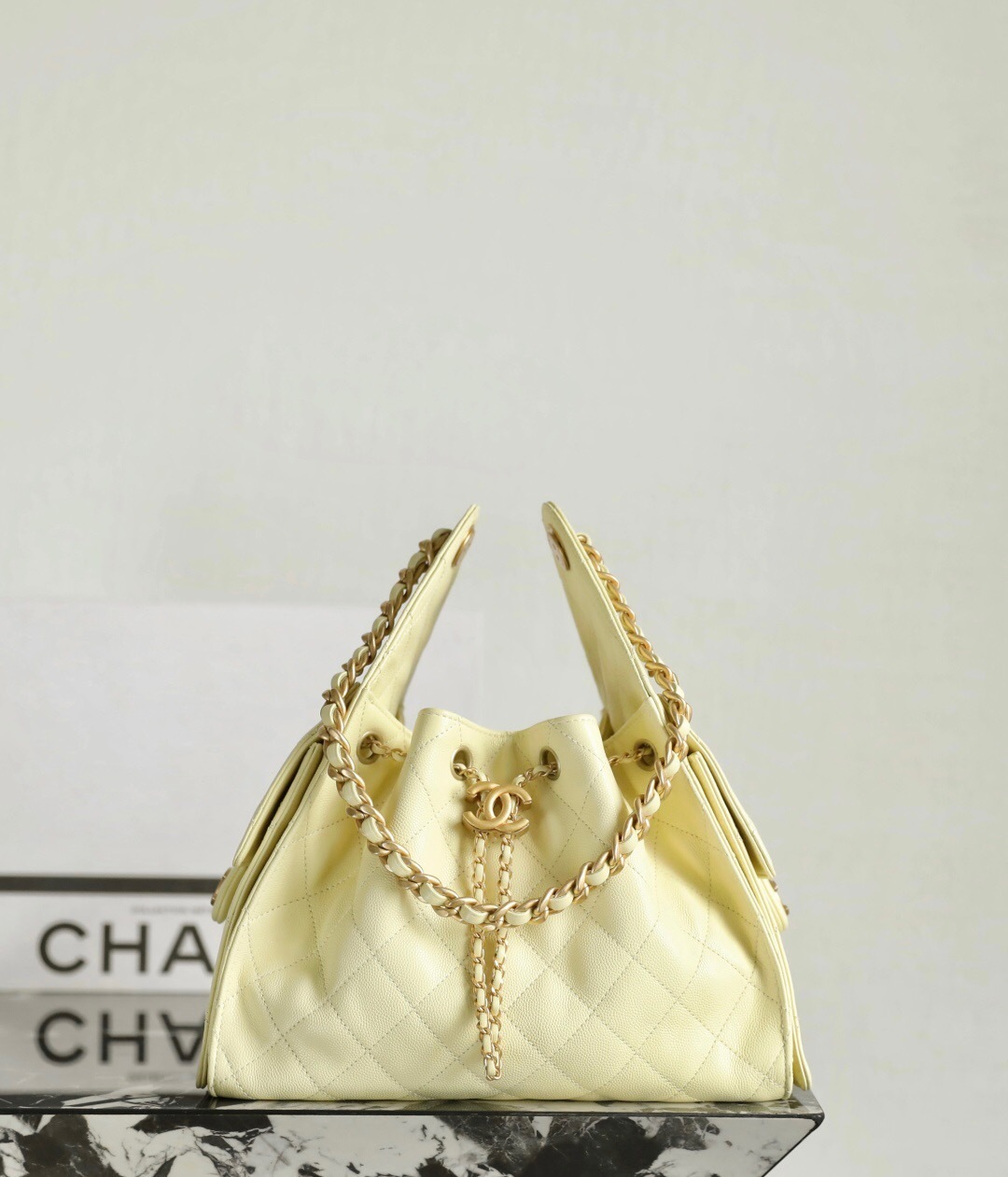 Chanel 25 Small Handbag in light yellow grained calfskin and gold-tone metal bucket bag