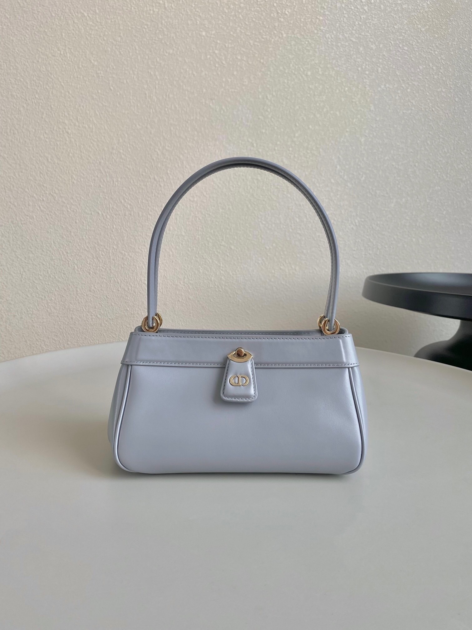 Dior Key Medium shoulder bag in a dusty ivory or grey shade.