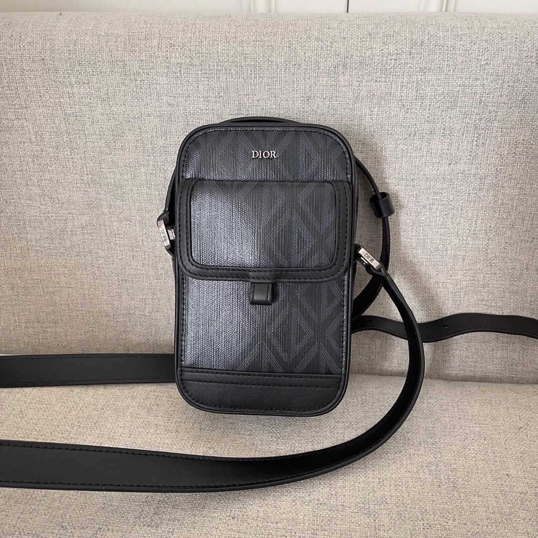 Dior Hit the Road vertical messenger bag with flap in black grained calfskin.