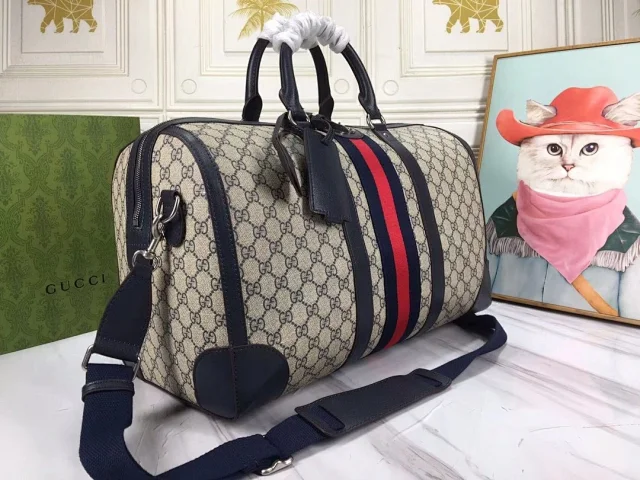 Gucci Savoy medium duffle bag in beige and blue GG Supreme canvas with blue leather trim and a blue and red Web stripe