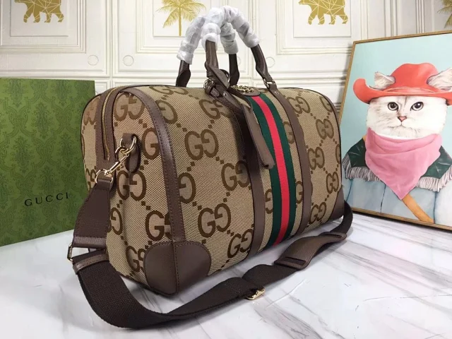 Gucci Jumbo GG duffle bag in beige and dark brown fabric with brown leather trim and a green and red web stripe