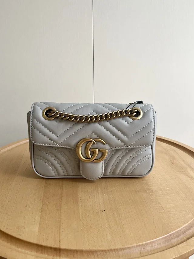 Gucci GG Marmont small shoulder bag in light grey matelassé chevron leather with antique gold-toned hardware